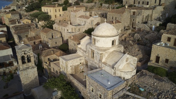 Drone view, aerial view of churches and stone houses in traditional village with vegetation,
