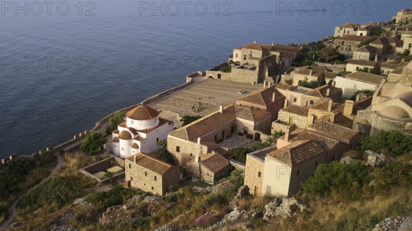Drone shot, Holy Church of the Virgin Mary Chrysaphitissa, historic coastal village with church and