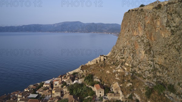 Drone shot, coastal landscape with cliffs, traditional village and mountain view, Monemvasia,