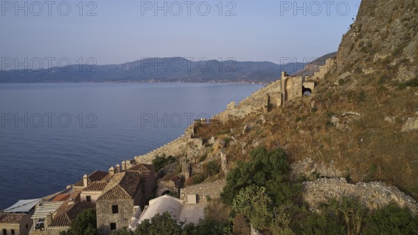 Drone shot, coastal landscape with medieval ruins and view of the blue sea, Monemvasia,