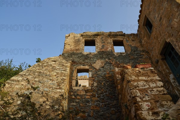 Soft morning light, the remains of an old stone building, window openings, blue sky, dilapidated,