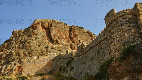 Mighty old city wall wraps around a dramatic rocky landscape, Monemvasia, Monemvassia, Malvasy,