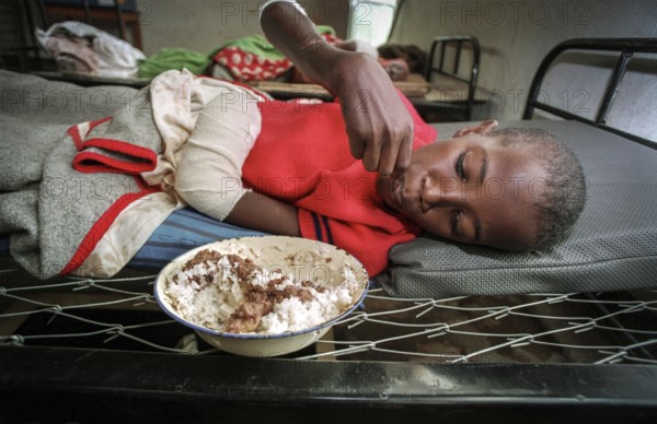 RWA Rwanda Kigali Injured Tutsi refugee children receive medical care in a makeshift hospital by