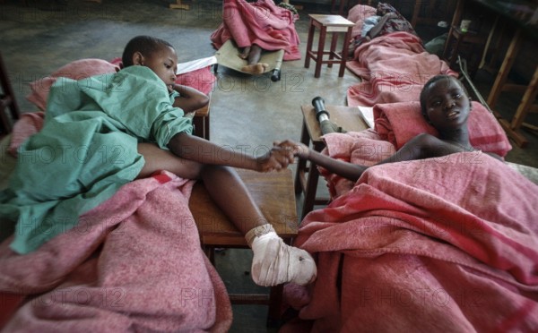 RWA Rwanda Kigali Injured Tutsi refugee children receive medical care in a makeshift hospital by