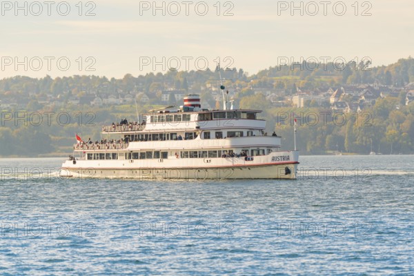 Large passenger ship on a lake with city and nature in the background, boat trip, Lake Constance,