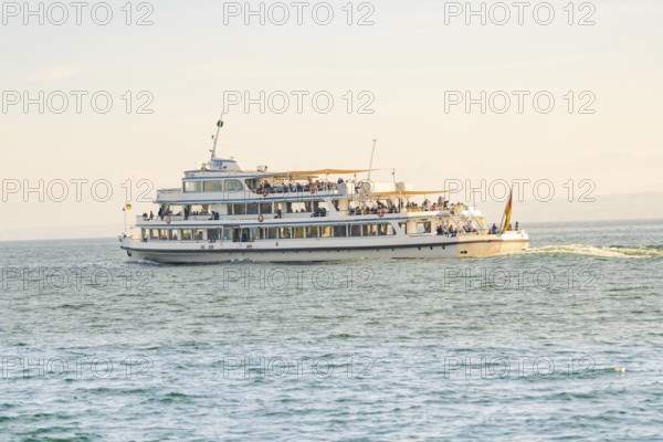 Large passenger ship full of people on calm water under a sunny sky, boat trip, Lake Constance,