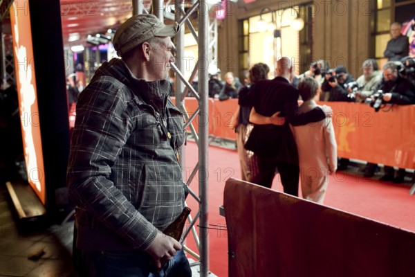 DEU, Germany, Berlin Man with beer in hand watches the hustle and bustle on the red carpet in front