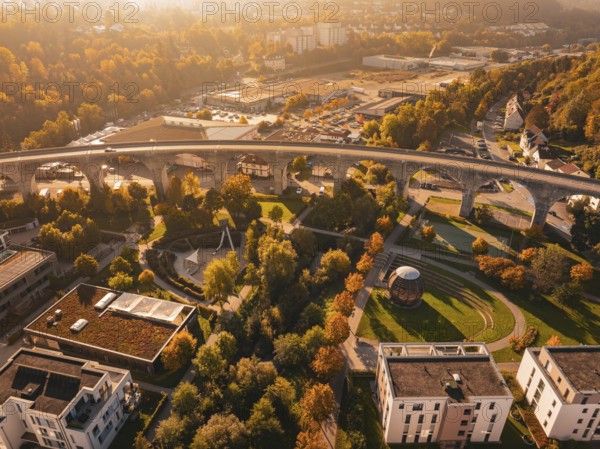 A viaduct within a city, surrounded by autumn-colored nature and modern buildings, Nagold, Black