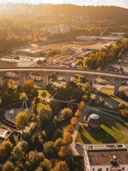 A viaduct spans a city characterized by autumn colors and various buildings, Nagold, Black Forest,