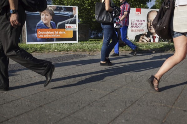DEU Germany Germany Berlin Pedestrians pass the election posters of Angela Merkel CDU and Peer
