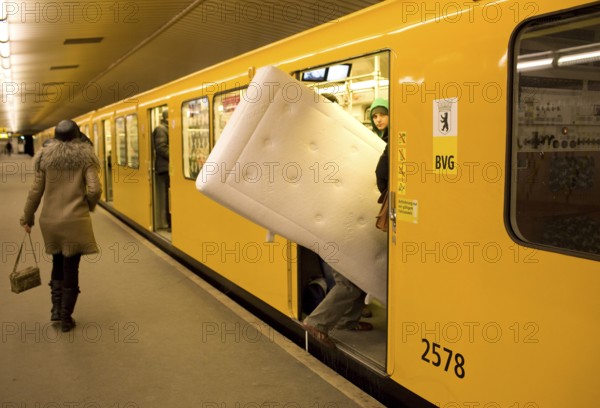 DEU Germany Berlin traveler with mattress boards the U 9 towards Osloer Straße in the