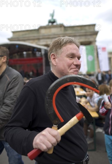 GERMANY A man carries a hammer and sickle in his hand at the DGB rally on May 1. Germany Berlin A