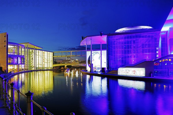 Illuminated Paul Löbe House and Marie Elisabeth Lüders House with the Spree River in the evening,