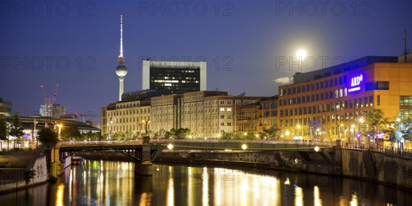 The river Spree in the government district with a full moon, the ARD capital studio and the Berlin