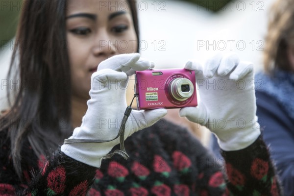 DEU Germany Germany Berlin HZB summer party at the Wannsee site. Woman wearing white gloves taking