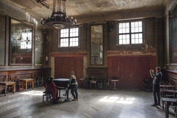 DEU Germany Germany Berlin Visitor films two woman playing a piano in the Hall of Mirrors at