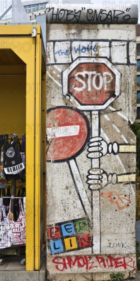 Old telephone box and painted piece of the Berlin Wall, gift shop Berlin loves you, Zimmerstraße,