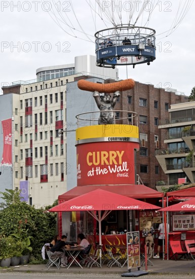 Curry at the Wall snack bar with passengers in the HiFlyer World Balloon, bizarre scene,