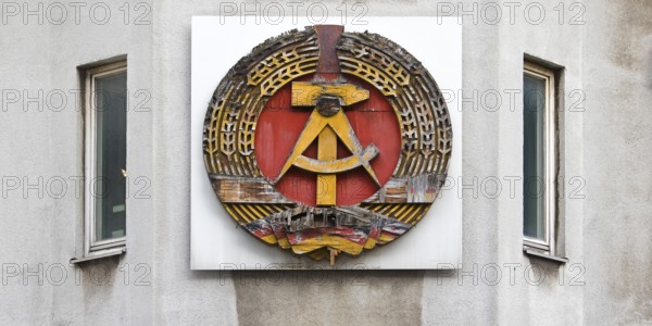 Old building of the Wall Museum — Museum Haus am Checkpoint Charlie with old GDR coat of arms,