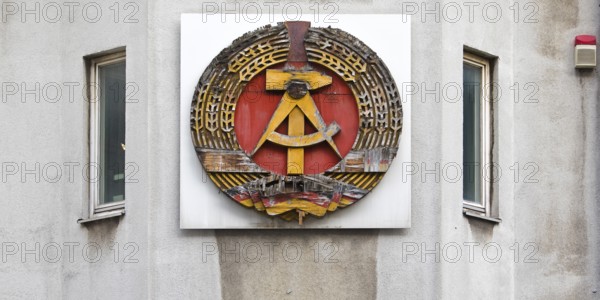 Old building of the Wall Museum — Museum Haus am Checkpoint Charlie with old GDR coat of arms,