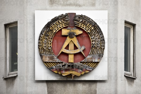 Old building of the Wall Museum — Museum Haus am Checkpoint Charlie with old GDR coat of arms,