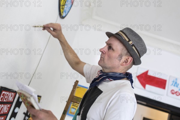DEU Germany Germany Berlin The artist Jim Avignon setting up an exhibition at the 'Retram' gallery