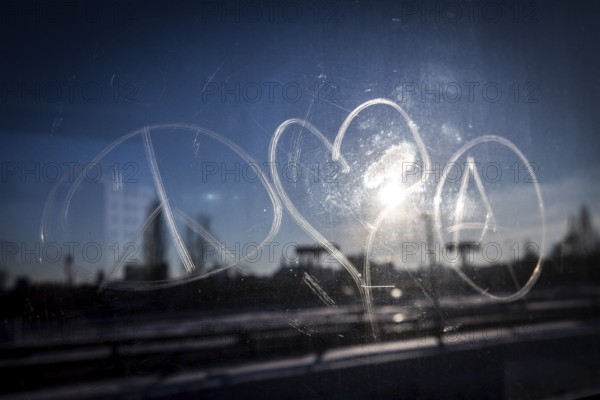 DEU Germany Germany Berlin The symbols of peace, love and anarchy are carved on the window of an