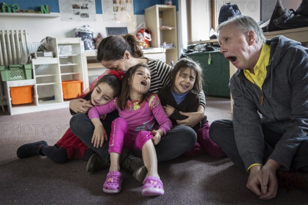 DEU Germany Germany Berlin An animation team entertains refugee children in an asylum center in