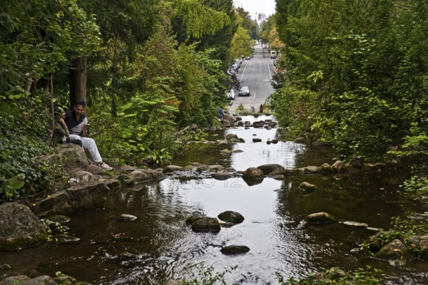 Artificial waterfall in Victoria Park with Großbeerenstraße in the background, Berlin-Kreuzberg,