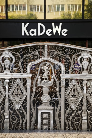 KaDeWe logo, Kaufhaus des Westens, with old forged grid in front of the entrance when the shop is