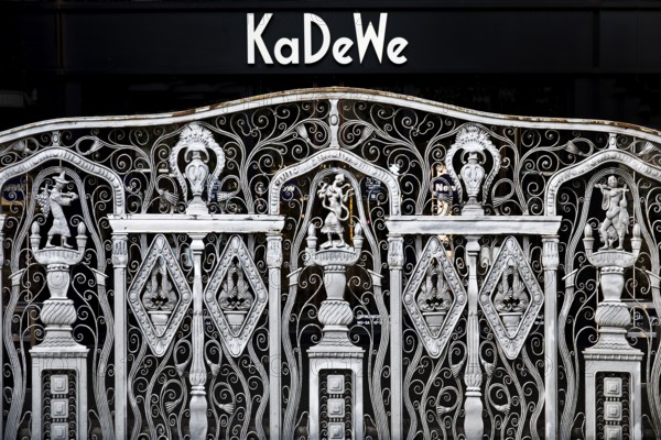 KaDeWe logo, Kaufhaus des Westens, with old forged grid in front of the entrance when the shop is