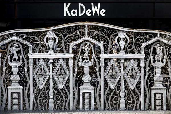 KaDeWe logo, Kaufhaus des Westens, with old forged grid in front of the entrance when the shop is