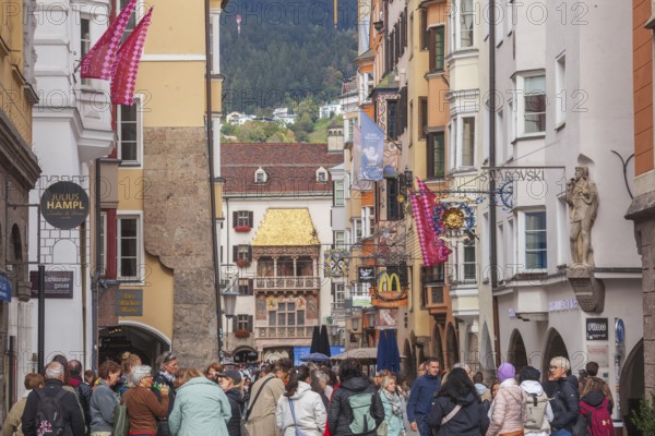 Golden roof, lots of people and historic houses in Herzog-Friedrich-Straße, Altstadt, Innsbruck,