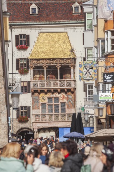 Golden roof, lots of people and historic houses in Herzog-Friedrich-Straße, Altstadt, Innsbruck,