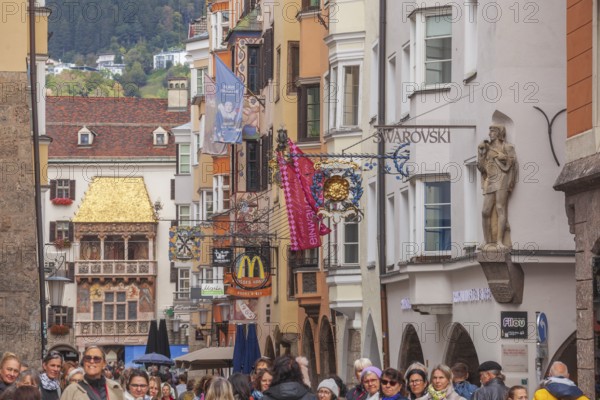Golden roof, lots of people and historic houses in Herzog-Friedrich-Straße, Altstadt, Innsbruck,