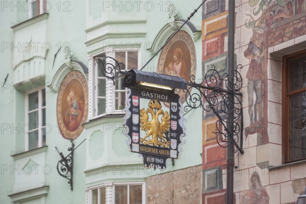 Old hanging sign from Gasthof Goldener Adler in Herzog-Friedrich-Straße, Old Town, Innsbruck,