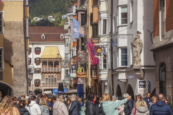 Golden roof, lots of people and historic houses in Herzog-Friedrich-Straße, Altstadt, Innsbruck,
