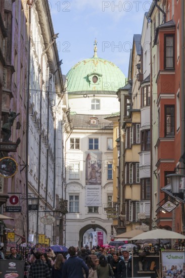 Hofgasse with Hofburg Imperial Palace, historic houses and many people, old town, Innsbruck, Tyrol,