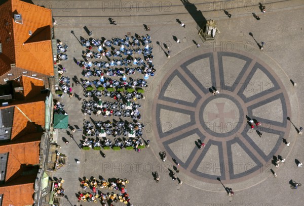 Hanseatic cross in front of the Bremen Roland on the market square of Bremen in front of the town