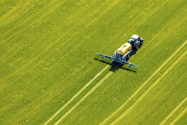 Aerial view, tractor with trailer working in the field, fertilising, Hellefeld, Sundern, Sauerland,