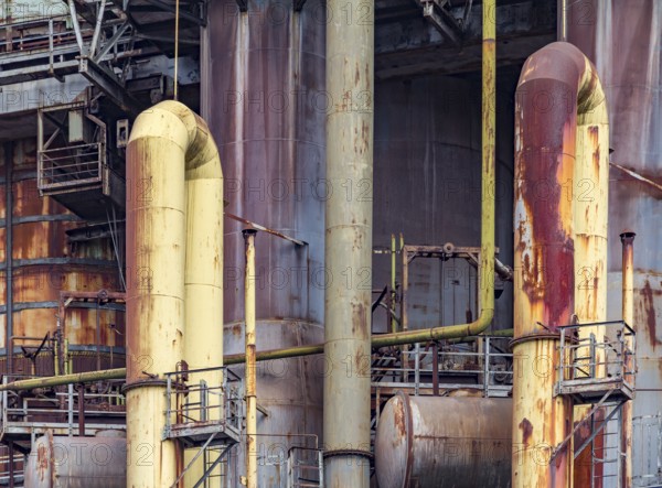 Weathered rusty industrial scenery with old corroded steel girders and metal tubes