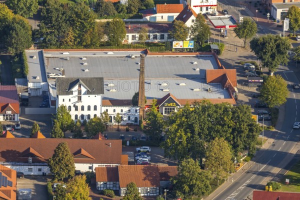 Aerial photograph, WEZ supermarket, stork's nest on the chimney of the Alte Kornbrennerei, Hille,