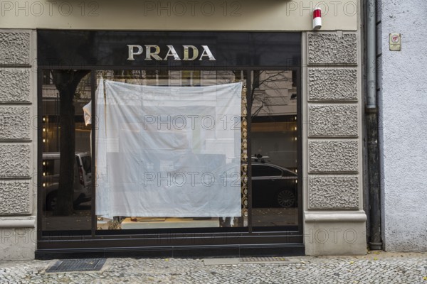 DEU Germany Germany Berlin A shop window of the luxury fashion company Prada is covered with a