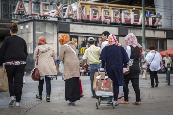 DEU Germany Germany Berlin Muslim family with a hackney carriage on Alexanderplatz. 'I love