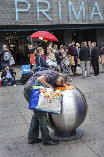 DEU Germany Germany Berlin A deposit bottle collector in front of the Primark store on