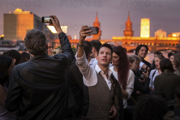 DEU Germany Germany Berlin Sunset on the terrace of the Fluxbau with the Oberbaum Bridge in the