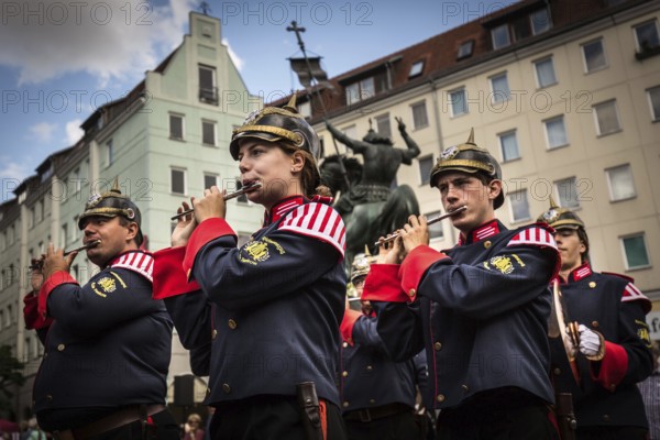 DEU Germany Germany Berlin A marching band with traditional uniforms marches through the Nikolai