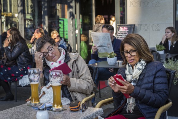 DEU Germany Germany Berlin Guests smoke, talk on the phone, read their mobile phones or look at the