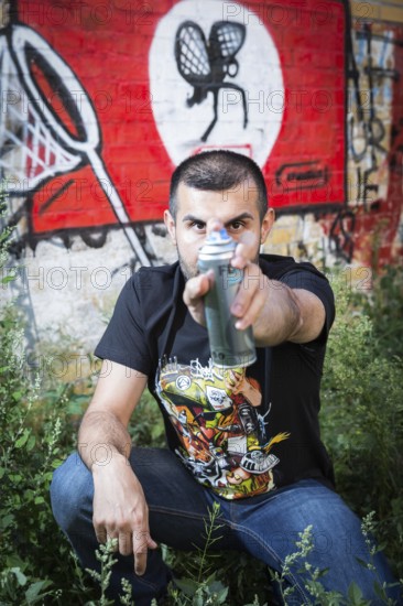 Germany Germany DEU Berlin Graffiti artist Ibo Omari in front of one of his works on a playground