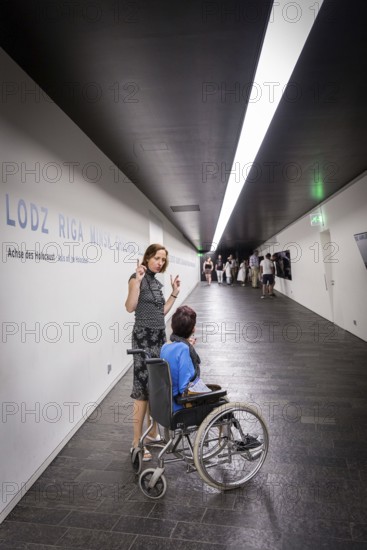DEU Germany Germany Berlin Disabled tourist in a wheelchair explores Berlin with a city guide.